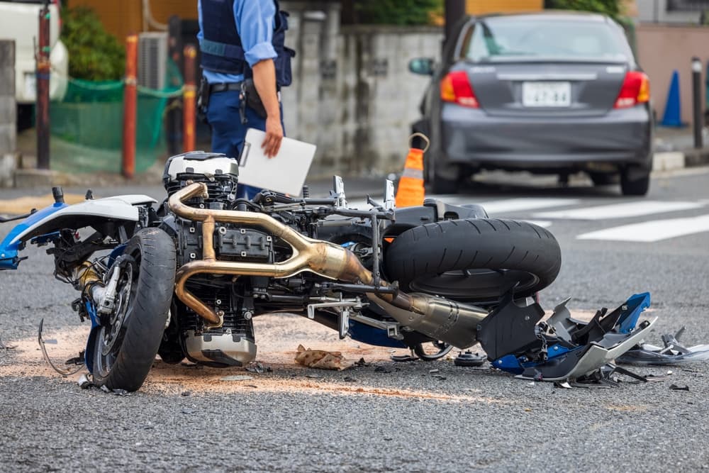 At an intersection, a motorcycle and a passenger car collided.
