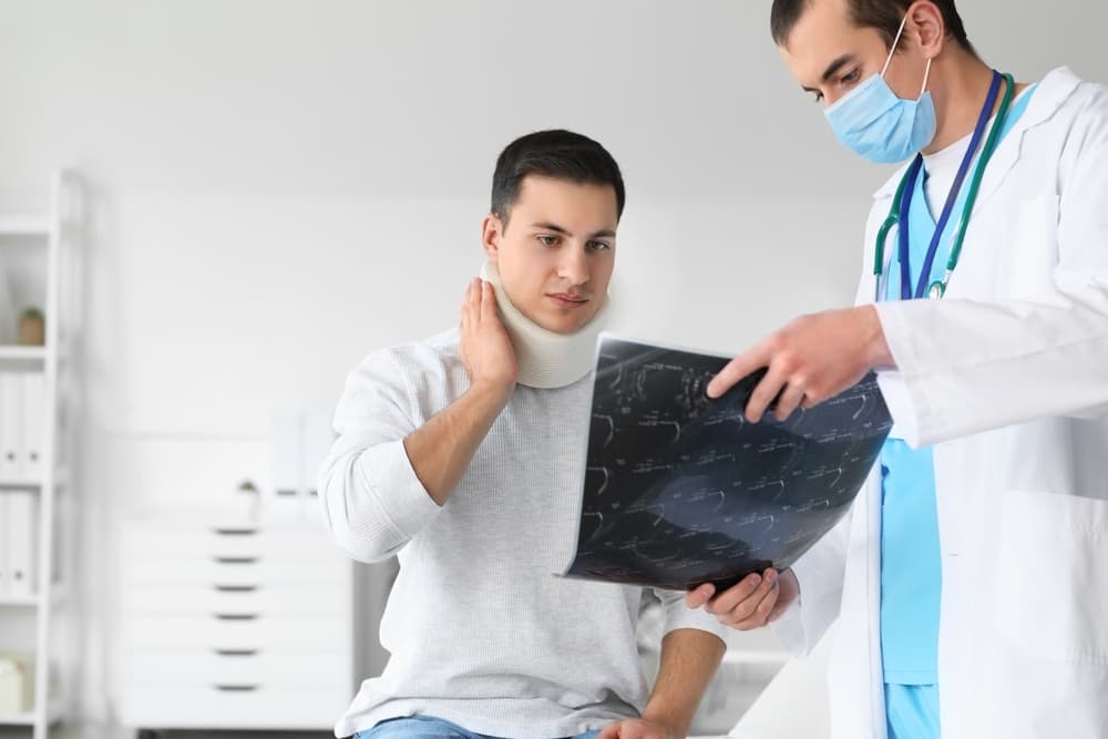 A young man seeks medical attention at a clinic for a neck injury.