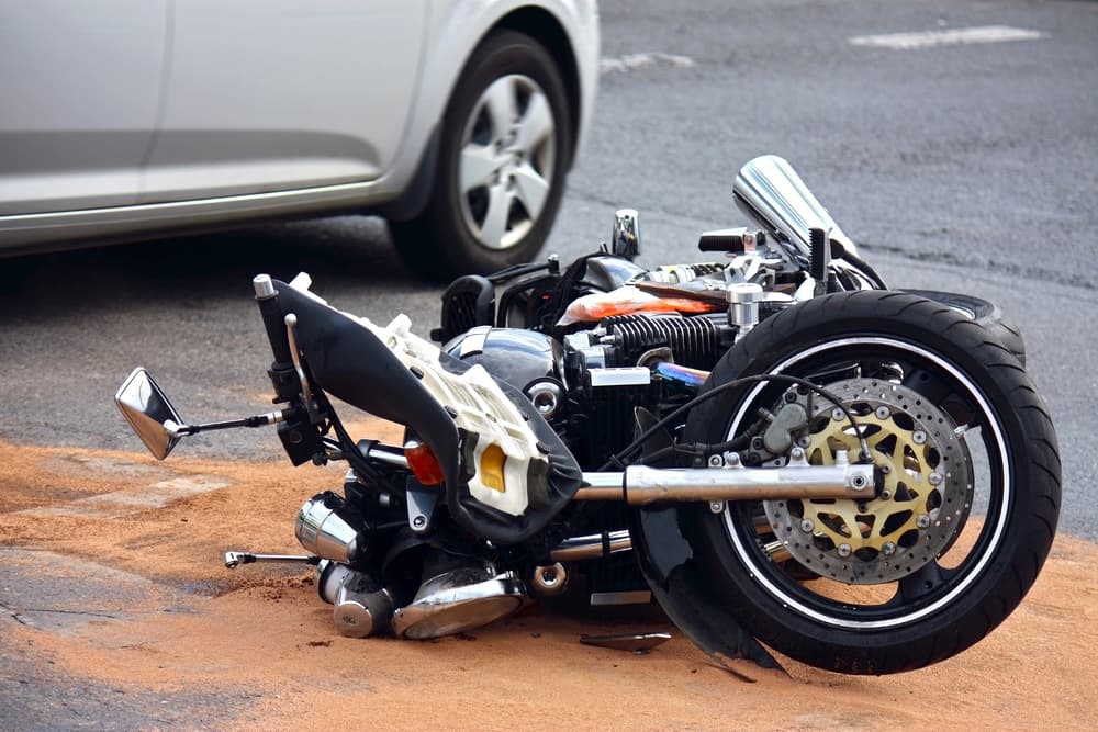  The accident involving a motorbike and a car on the city street.